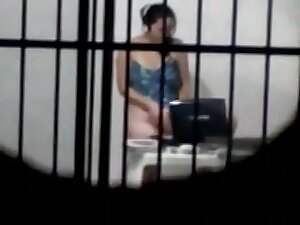 sexy brunette masterbates in a cell behind bars while on her laptop porn
