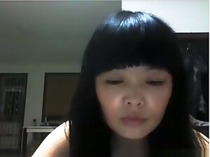 Chinese girl plays with her hairy pussy