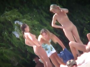 A group of girls showing off their naked bodies at the beach