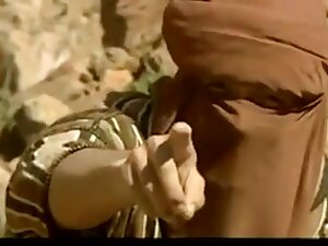 Arab woman in the desert having sex with a group of men